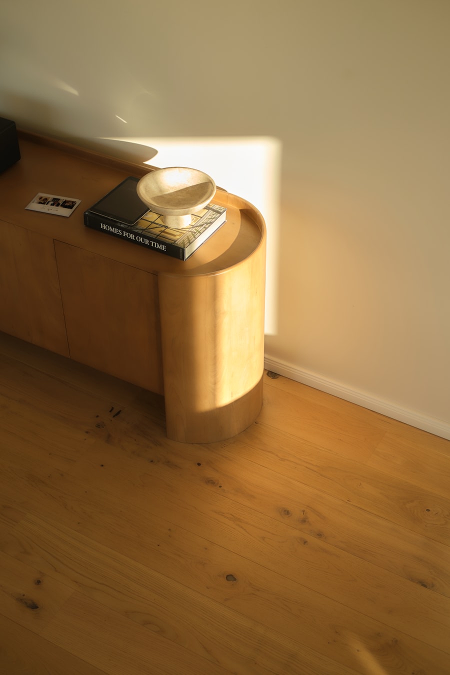 Late sun falling across a low oak cabinet and floor.