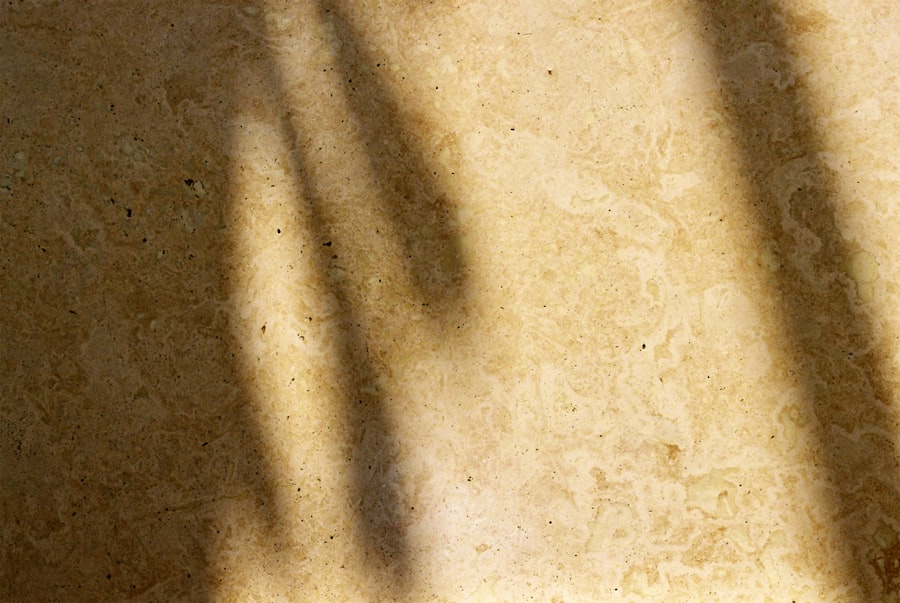 Soft window shadows across a mottled cream stone floor.